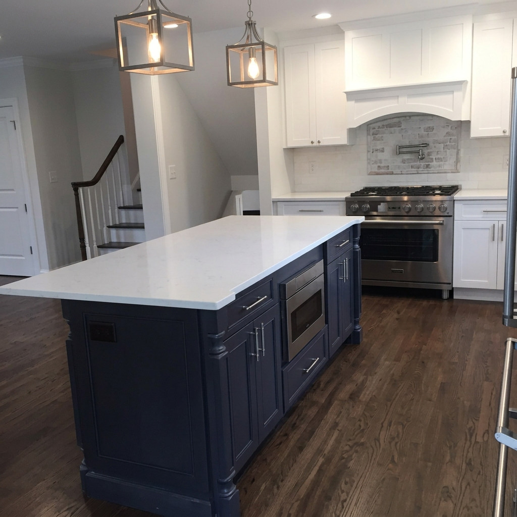 Milan Construction kitchen remodel in New Jersey with a navy painted island, white quartz countertops, lantern pendants, and a stainless professional range